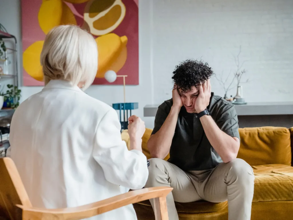A therapist and client in a therapy session in Los Angeles, sitting across from each other in a calm, modern setting